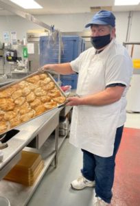 Foodnet Meals on Wheels cook Gary Armstrong with a tray of food for the pre-prepared meals that the nonprofit provides to individuals and families in need. Foodnet recently expanded its services to provide meals to those in quarantine.